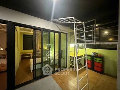 Modern loft-style bedroom with sliding glass doors and vibrant decor