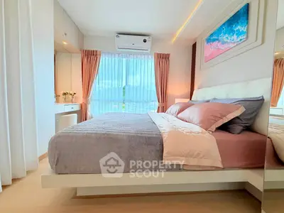 Modern bedroom with stylish decor and large window offering natural light.