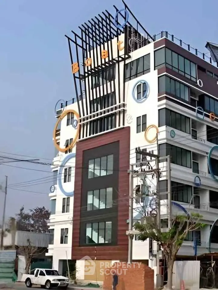 Modern multi-story building with unique circular design elements and contemporary facade.