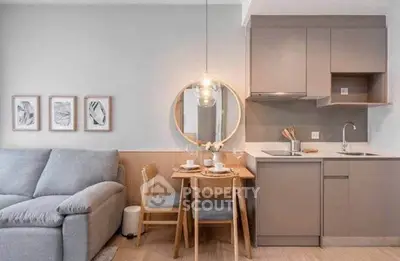 Modern compact living room with cozy sofa and stylish kitchen area