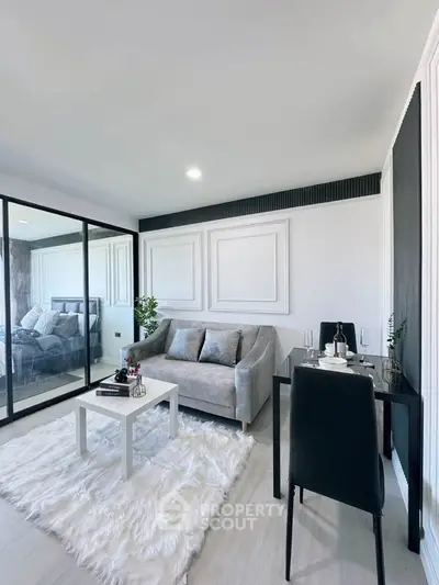Modern living room with plush sofa, elegant dining area, and stylish decor in a contemporary apartment.