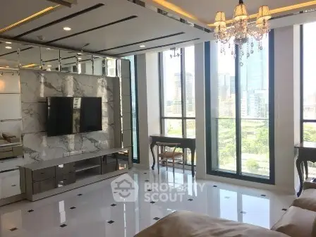 Luxurious living room with marble accents and city view, featuring elegant chandelier and modern decor.