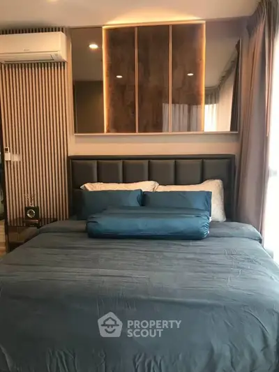 Luxurious bedroom with modern decor and plush bedding in upscale apartment.