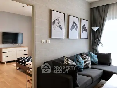 Chic modern living room with plush sofa set, stylish wall art, and ample natural light, perfect for urban living.