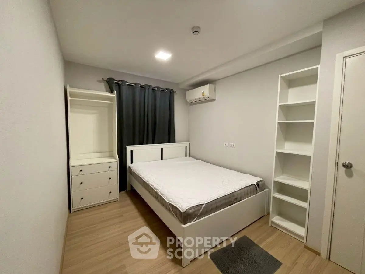 Modern minimalist bedroom with built-in shelves and air conditioning