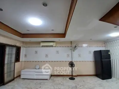 Spacious living room with modern ceiling design and air conditioning