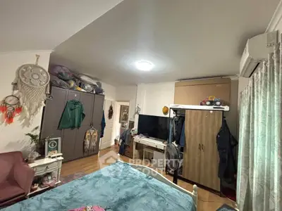 Cozy bedroom with ample storage and modern decor, featuring a comfortable bed and stylish furnishings.