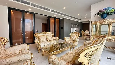 Luxurious living room with ornate furniture and elegant decor in a high-end apartment.