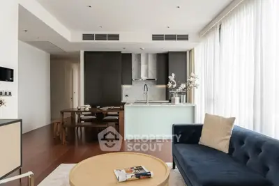 Modern open-plan living room with sleek kitchen and elegant furnishings