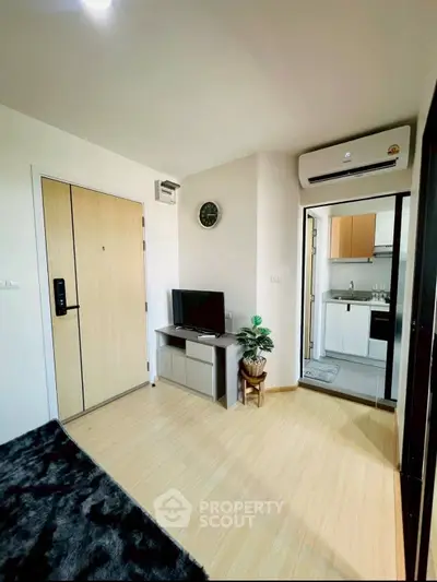 Modern apartment interior with cozy living area and kitchen view