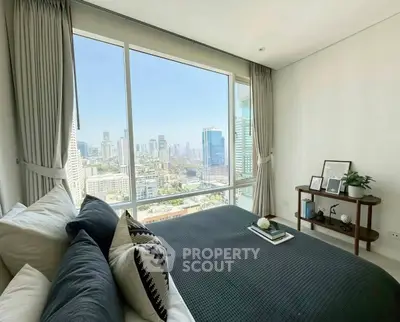 Luxurious bedroom with stunning city view from large window, modern decor and cozy ambiance.