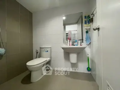 Modern bathroom with sleek fixtures and neutral tiles, perfect for a contemporary home.