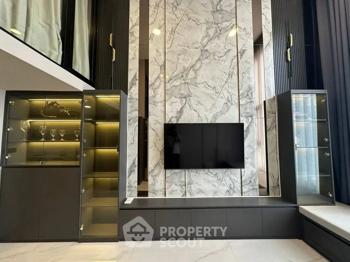 Luxurious modern living room with marble accent wall and sleek cabinetry