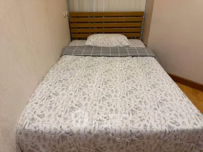 Cozy bedroom with a comfortable bed and stylish headboard, perfect for restful nights.