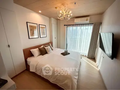 Modern bedroom with city view, stylish decor, and natural light