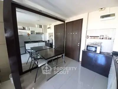 Modern kitchen with sleek design, featuring stainless steel appliances, glossy countertops, and ample storage space, perfect for culinary enthusiasts.