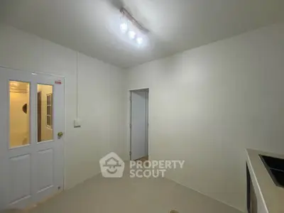Minimalist kitchen with closed layout and modern lighting