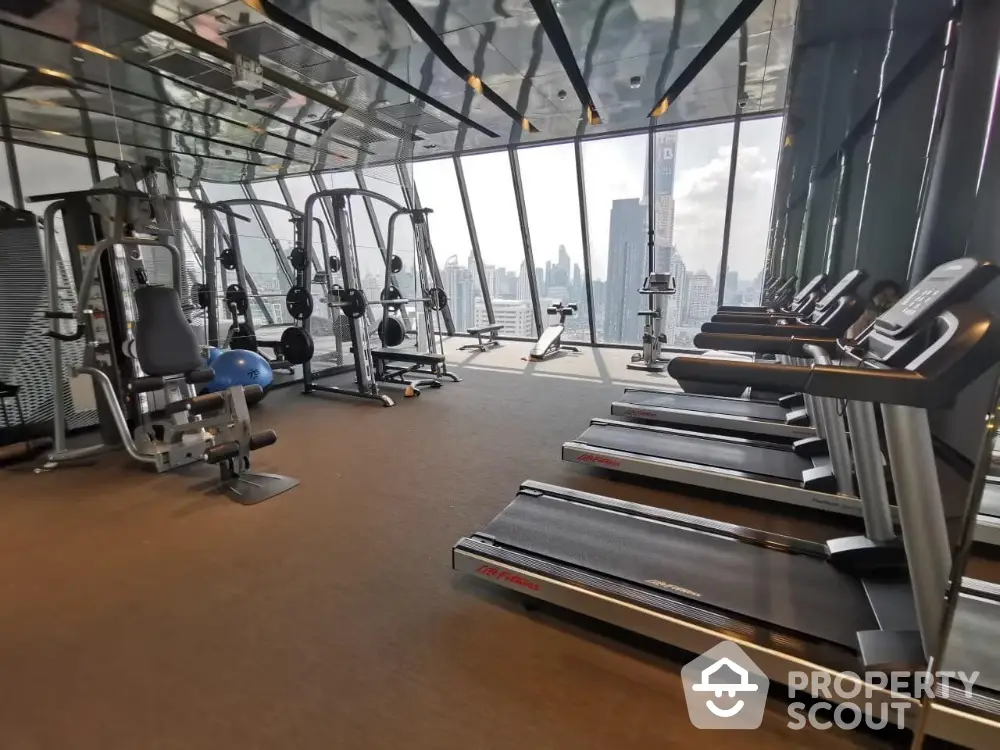 Modern gym with city view and state-of-the-art fitness equipment