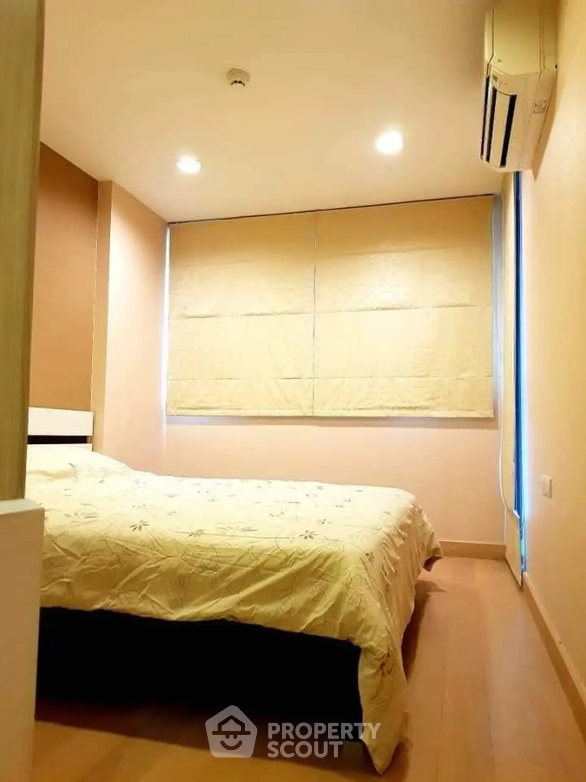 Cozy bedroom with soft lighting and air conditioning, perfect for relaxation.