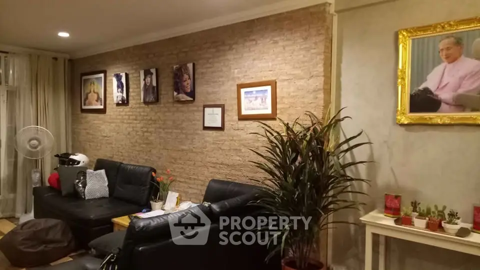 Cozy living room with exposed brick wall, stylish decor, and comfortable seating.