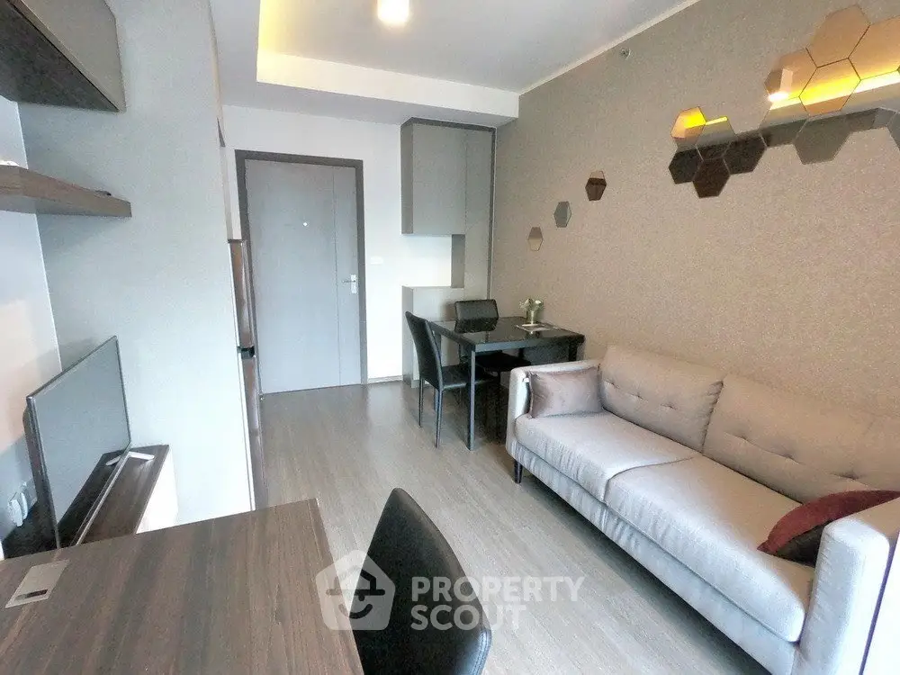 Modern living room with stylish decor and cozy seating in a contemporary apartment.