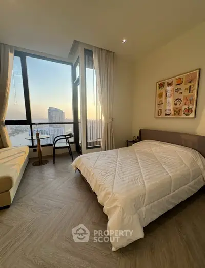 Modern bedroom with large windows offering stunning city views