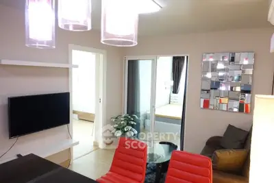 Modern living room with stylish decor and red chairs, featuring a wall-mounted TV and unique mirror design.