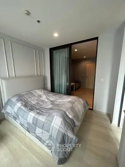 Modern bedroom with stylish decor and cozy bed in a contemporary apartment.
