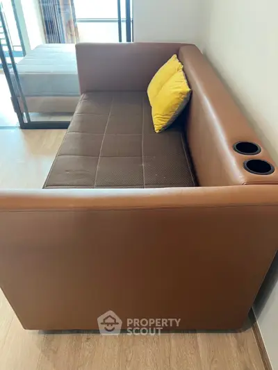 Modern brown leather sofa with yellow cushions in a stylish living room