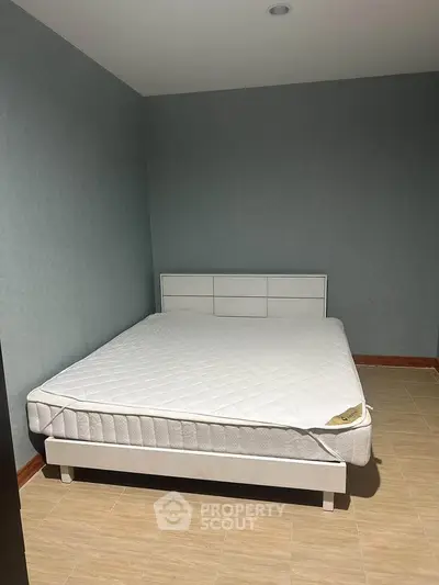 Spacious bedroom with minimalist design and comfortable bed in modern apartment.