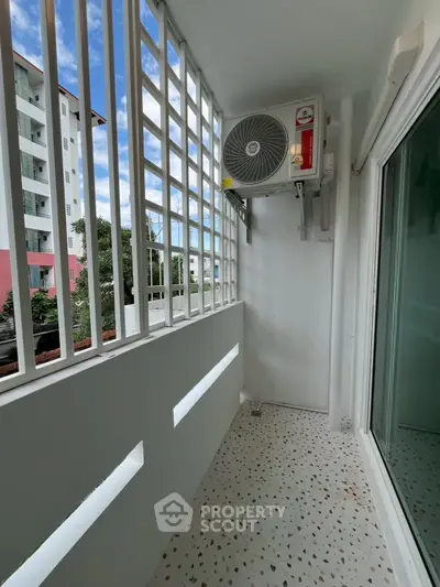 Modern balcony with air conditioning unit and city view