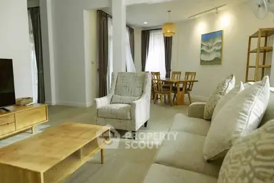 Spacious living room with modern furniture and dining area in open layout