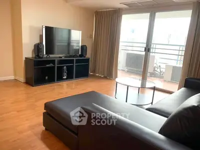 Spacious living room with modern furniture and balcony access, perfect for urban living.
