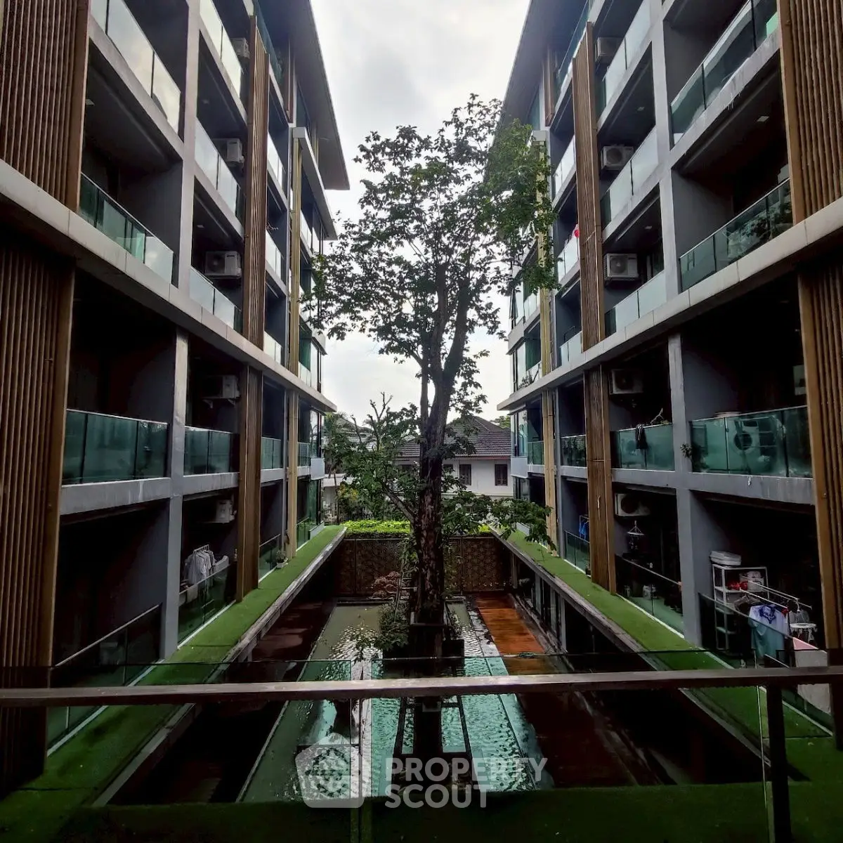 Modern apartment building with central courtyard and lush greenery