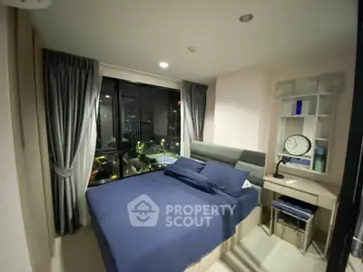 Cozy bedroom with city view, modern decor, and ample natural light.