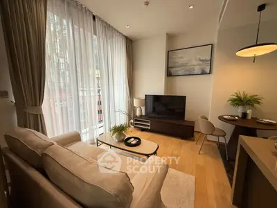 Modern living room with elegant decor, large windows, and cozy seating area in a stylish apartment.