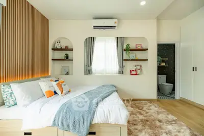 Modern cozy bedroom with stylish decor and ensuite bathroom