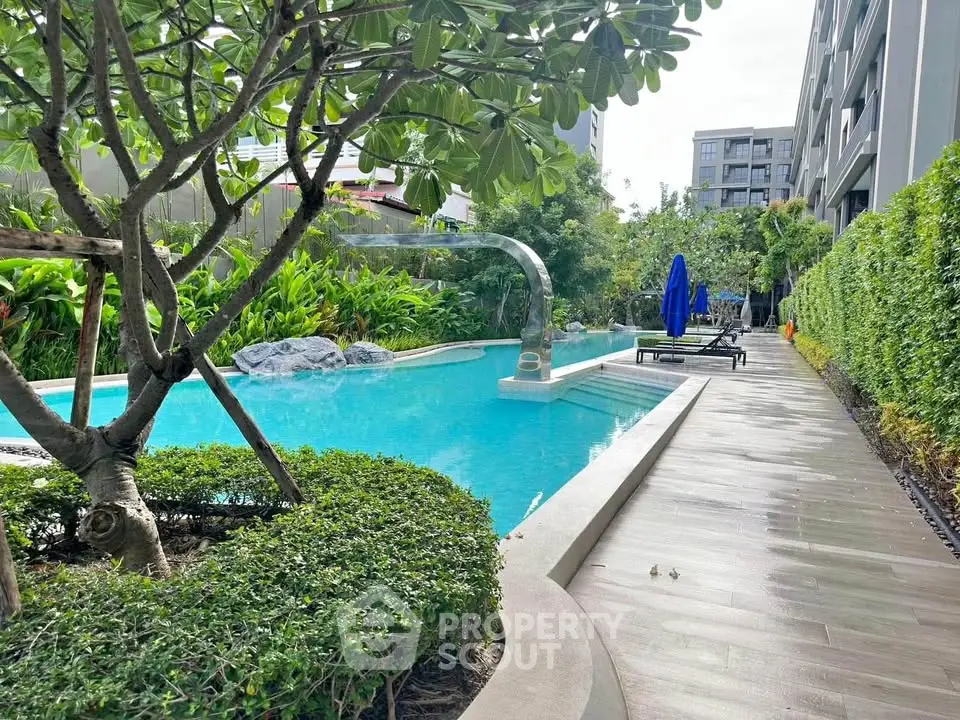 Luxurious residential pool area with lush greenery and modern design