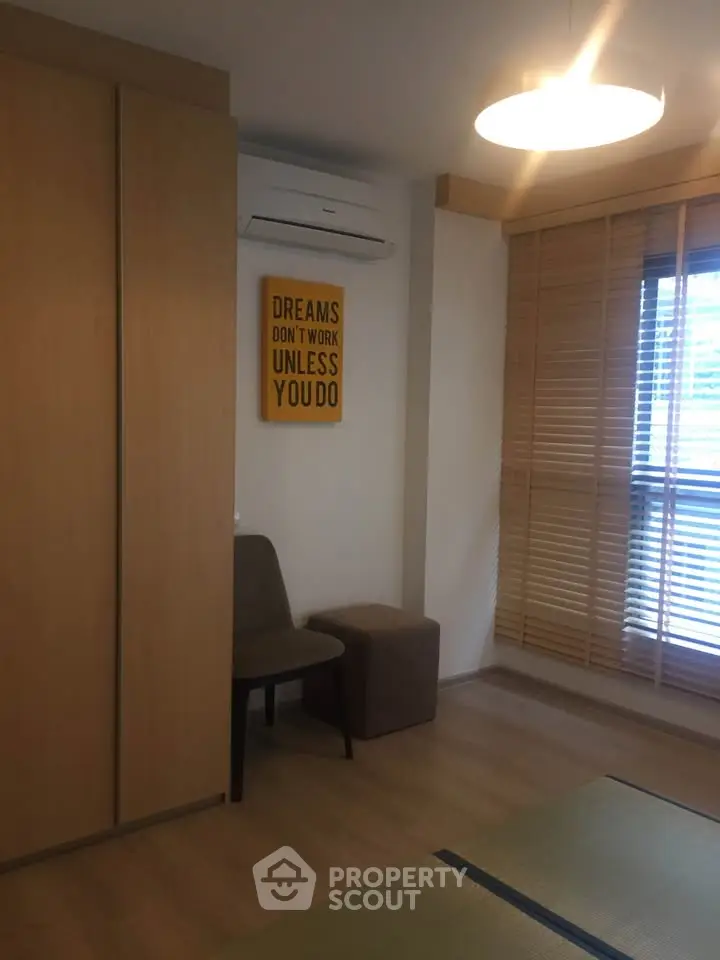 Cozy bedroom with modern decor and motivational wall art, featuring wooden blinds and soft lighting.