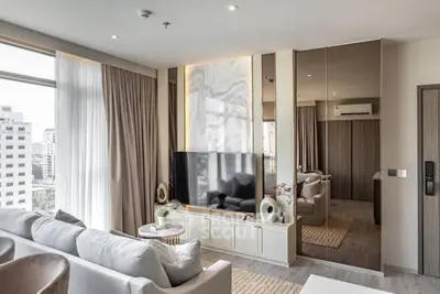 Luxurious modern living room with large windows and stylish decor in a high-rise apartment.