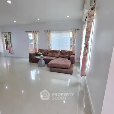 Spacious living room with modern sofa and natural light