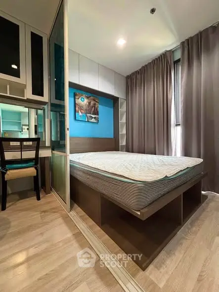 Modern bedroom with stylish decor and ample storage in a cozy apartment.