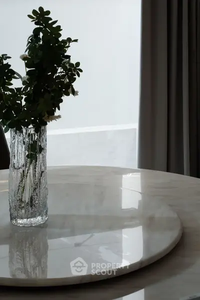 Elegant marble table with decorative vase in modern interior setting