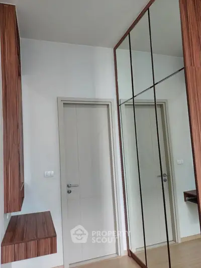 Modern bedroom with mirrored wardrobe and wooden accents