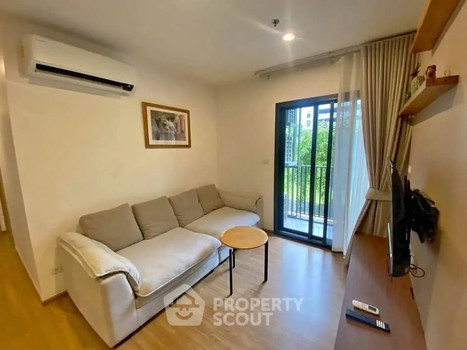 Modern living room with cozy sofa and balcony view in a stylish apartment.