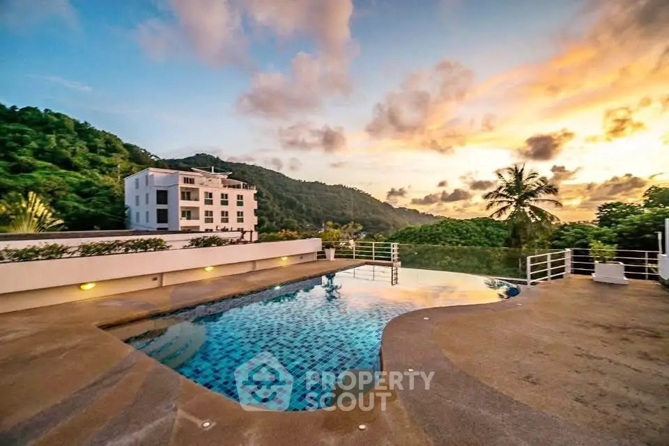 Stunning rooftop pool with breathtaking sunset views and lush greenery, perfect for luxury living.