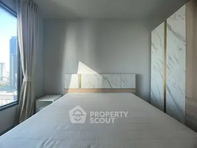 Modern minimalist bedroom with large window and city view