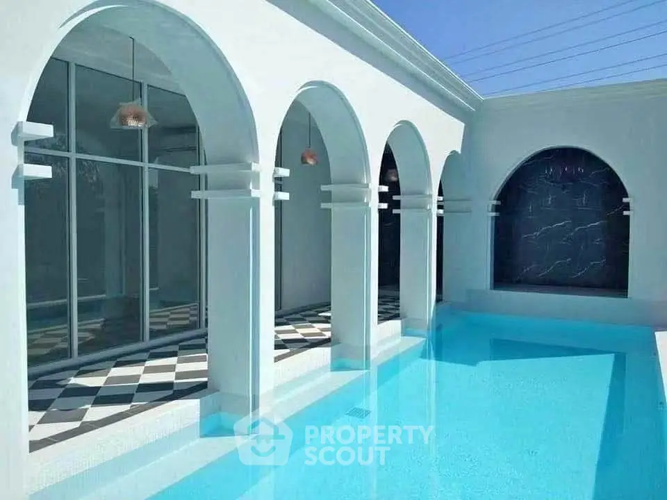 Luxurious modern poolside with elegant arches and pristine blue water