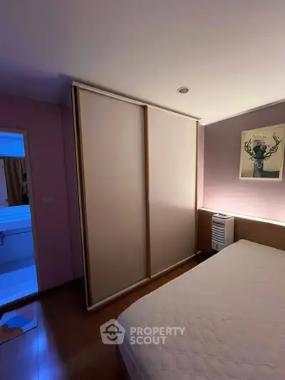 Cozy bedroom with sliding closet doors and modern decor