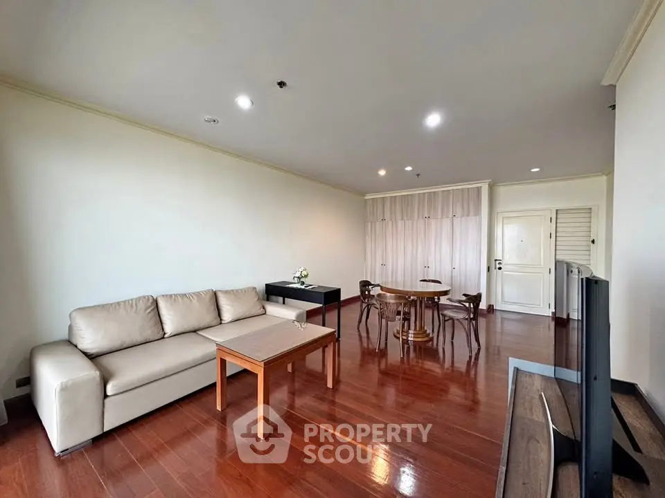 Spacious living room with elegant wooden flooring and modern furniture